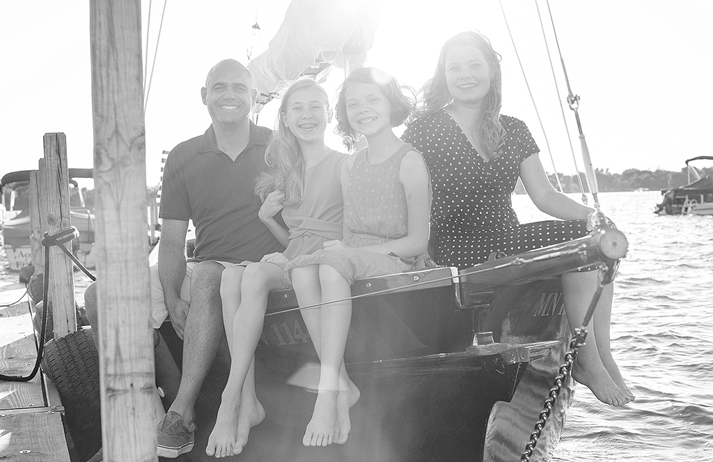 portrait of family on sailboat by pixelations photography
